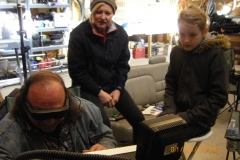 Deb and AJ watching Dan setup the radio